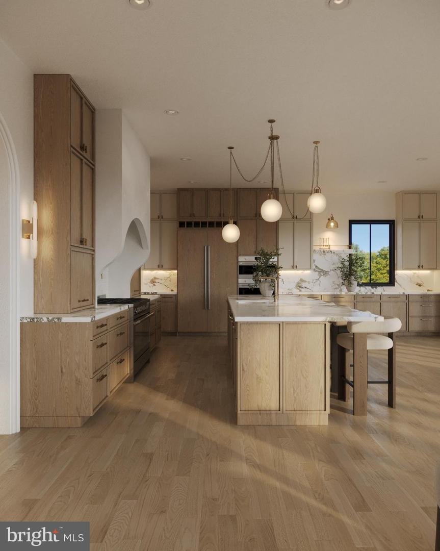 Second rendering of the kitchen island with upholstered stools and the arched opening to the adjoining rooms